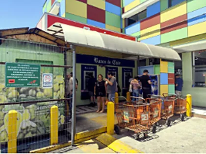 Cajeros automáticos junto a un acceso, con carros de compra